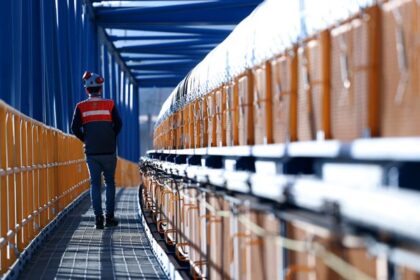 Plusmining, man walking inside a mining insdutry